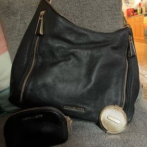 Black Michael Kors bag with mini bag and compact mirror.